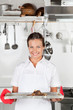 Foto: Female Chef With Tray Of Meat Female Chef With Tray Of Meat
