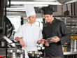 Photo: Male chefs Preparing Food Together Male chefs Preparing Food Together