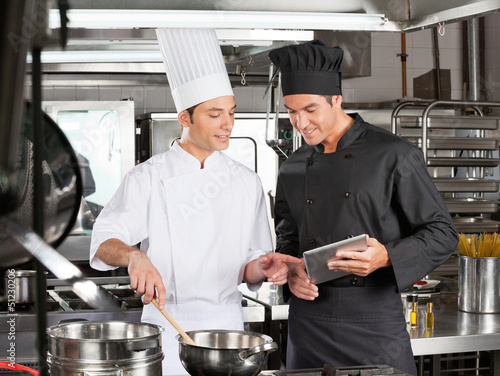 Photo: Male chefs Preparing Food Together Male chefs Preparing Food Together