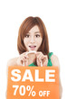 surprised  woman showing shopping bag with sale written