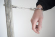 Close-up. Arrested man handcuffed on one hand