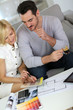 Couple looking at paint colors for new home