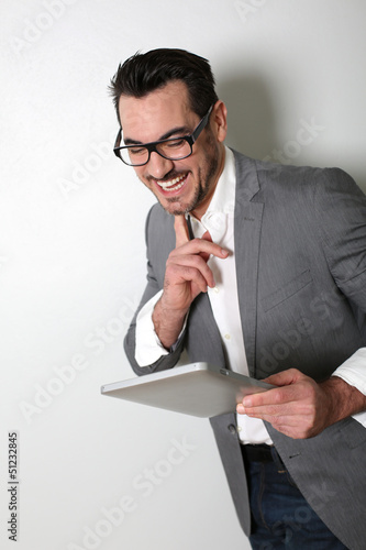 Photo: Cheerful salesman using digital tablet Cheerful salesman using digital tablet