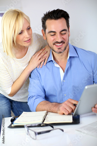 Photo: Middle-aged couple working from home Middle-aged couple working from home