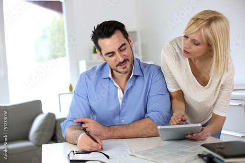 Photo: Middle-aged couple working from home Middle-aged couple working from home