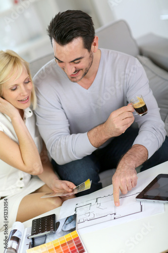 Photo: Couple looking at paint colors for new home Couple looking at paint colors for new home