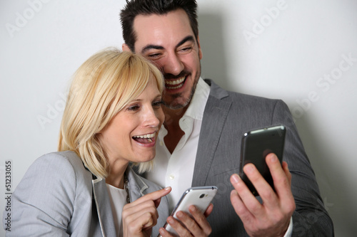 Photo: Couple using smartphone together Couple using smartphone together