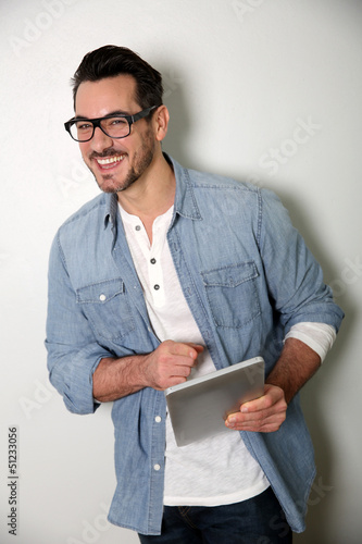 Photo: Man with eyeglasses using digital tablet, isolated Man with eyeglasses using digital tablet, isolated