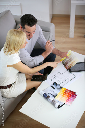 Photo: Couple looking at paint colors for new home Couple looking at paint colors for new home