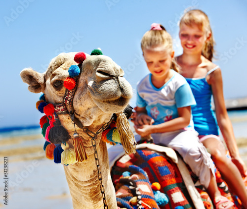 Photo: Tourists riding camel on the beach of Egypt. Tourists riding camel on the beach of Egypt.