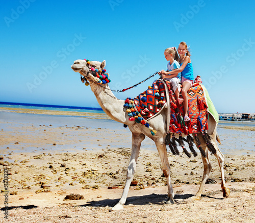 Photo: Tourists riding camel on the beach of Egypt. Tourists riding camel on the beach of Egypt.