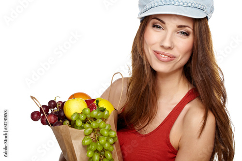 Photo: Young woman with a grocery shopping bag. Isolated on white backg Young woman with a grocery shopping bag. Isolated on white backg