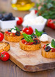 Photo: Bruschetta with mozzarella on chopping board Bruschetta with mozzarella on chopping board