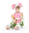 Photo: Child in bunny hare costume holding carrots. White background Child in bunny hare costume holding carrots. White background
