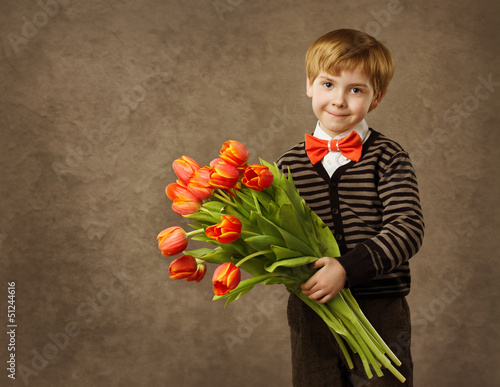 Photo: Child holding flowers bouquet of tulips, vintage style Child holding flowers bouquet of tulips, vintage style