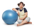 Foto: Overweight woman exercising with blue ball. Overweight woman exercising with blue ball.
