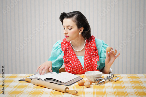 Photo: Girl reads a cookbook Girl reads a cookbook