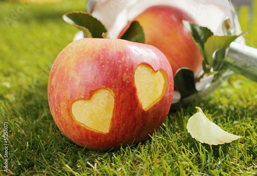 Photo: Fresh apple with incised hearts Fresh apple with incised hearts