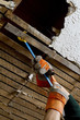 close up of person pulling apart ceiling lathe with crowbar.
