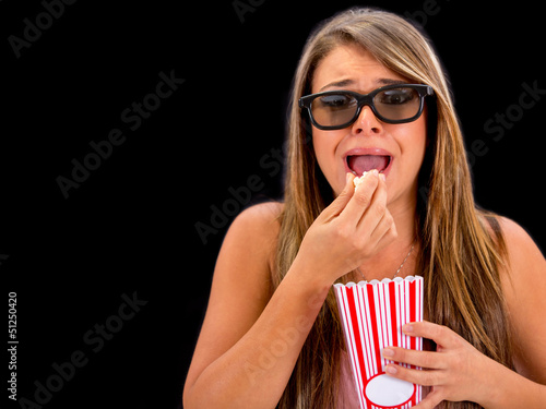 Photo: Scared woman watching 3D movie Scared woman watching 3D movie