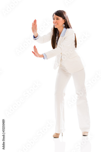 Photo: Business woman pushing something Business woman pushing something