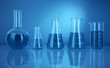 Test tubes with colorful liquids in blue light
