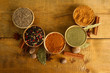 bowls with spices, on wooden background