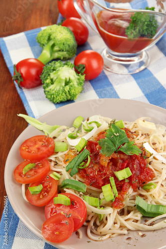 Photo: Tasty spaghetti with sauce and vegetables Tasty spaghetti with sauce and vegetables