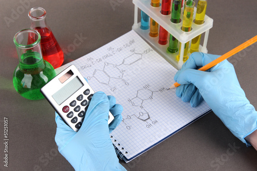 Photo: Hand scientist writing formulas Hand scientist writing formulas