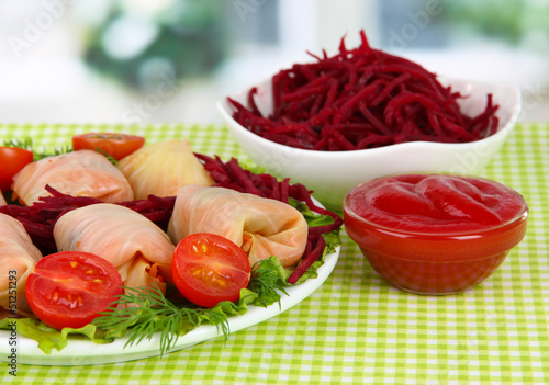 Photo: Stuffed cabbage rolls on table in room Stuffed cabbage rolls on table in room