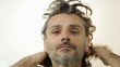man combing his hair over white