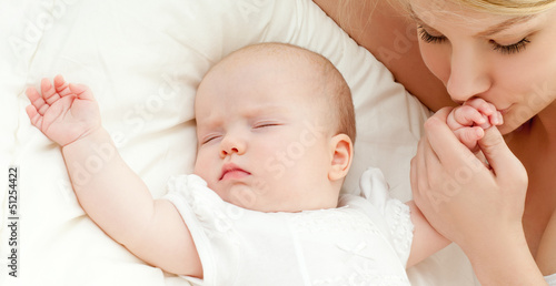 Photo: happy mother with baby over white happy mother with baby over white