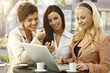 Pretty businesswomen using laptop outdoors