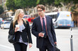 Businessman And Businesswoman In Street With Takeaway Coffee
