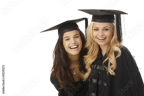 Photo: Happy graduates in graduation cap Happy graduates in graduation cap