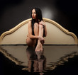Girl with wet clothes sitting in the black water 
