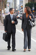 Photo: Businessman And Businesswoman In Street With Takeaway Coffee Businessman And Businesswoman In Street With Takeaway Coffee