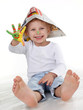 Cute little boy is proud of his coloured hands