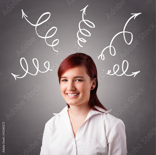 Photo: Young woman thinking with arrows overhead Young woman thinking with arrows overhead