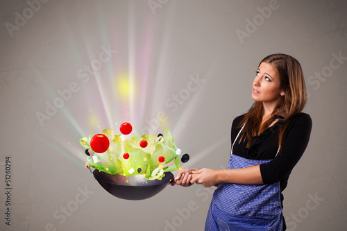 Photo: Young woman cooking fresh vegetables Young woman cooking fresh vegetables
