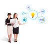 beautiful young women presenting light bulb with colorful graphs