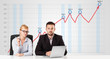 Businessman and businesswoman calculating stock market with risi