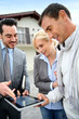 Real-estate-agent showing house plan on digital tablet