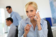 Businesswoman on the phone taking note on agenda