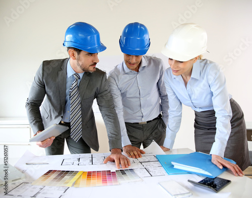 Photo: Team of architects presenting construction project Team of architects presenting construction project