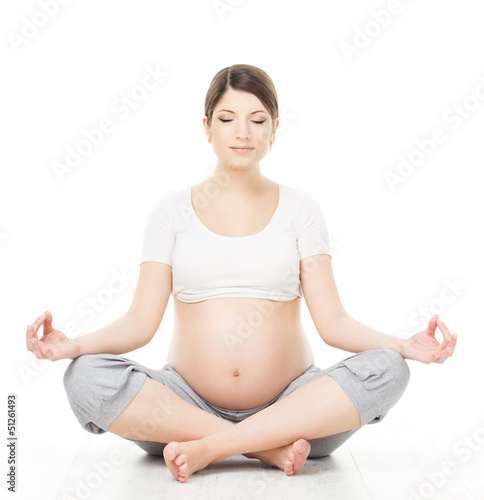 Photo: Pregnant woman relax doing yoga, sitting in lotus position Pregnant woman relax doing yoga, sitting in lotus position