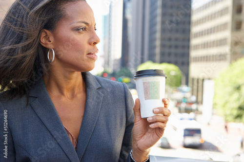 Photo: Businesswoman Drinking Takeaway Coffee Outside Office Businesswoman Drinking Takeaway Coffee Outside Office