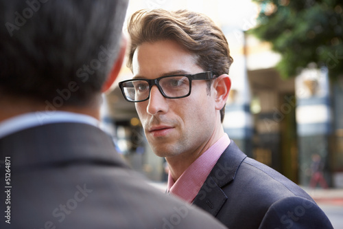 Photo: Two Businessman Chatting Outside Office Two Businessman Chatting Outside Office
