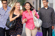 Foto: Two Couples With Bored Men Carrying Partners Bags Two Couples With Bored Men Carrying Partners Bags