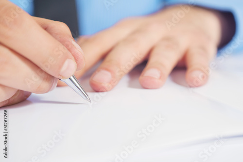 Photo: Businessman writing a note Businessman writing a note